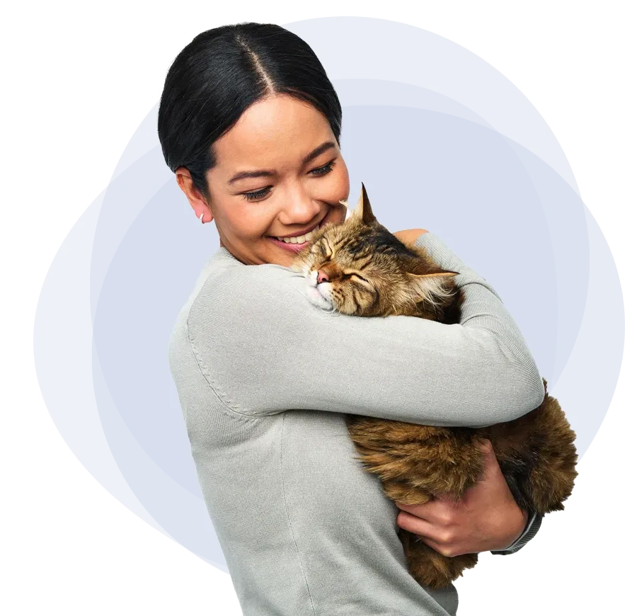 A female pet insurance customer holding a fluffy cat ready to leave Trupanion pet insurance reviews.