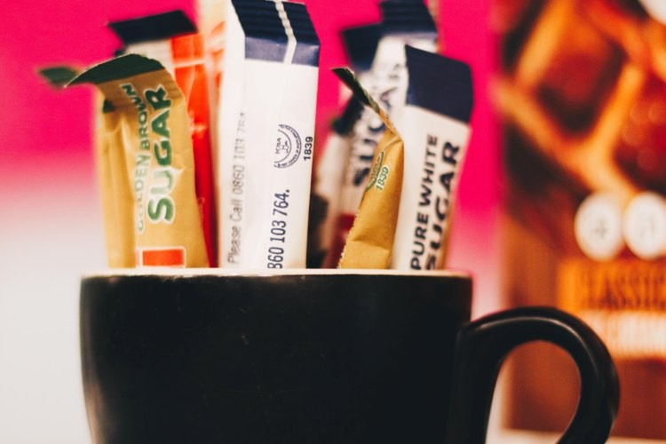 Sugar packets in a coffee mug
